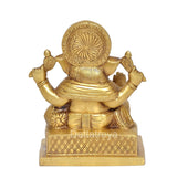 Brass Ganesha idol, large circular halo, four arms, patterned pedestal, 7 inch height