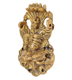Brass evil eye guardian wall ornament with detailed face and hands, round base