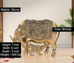 Bronze cow with calf figurine, decorative temple-style panels, 7 inch tall