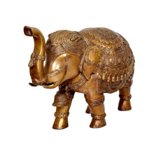 Brass elephant figurine rear-side view with ornate engraved head and raised tail