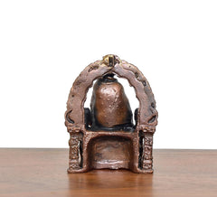 Copper Shirdi Sai Baba idol, close-up front, arched backdrop and patterned pedestal