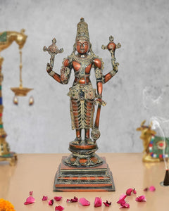 Brass Lord Vishnu standing idol with four arms, ornate crown and painted details