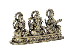 Close-up brass trio idol set with carved details on the pedestal base