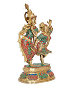 Brass Radha-Krishna idol, angled view showing patterned attire and gold-toned base