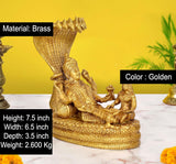 Golden brass Vishnu with Lakshmi and small figures on coiled serpent base