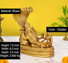 Golden brass Vishnu with Lakshmi and small figures on coiled serpent base