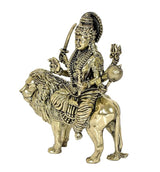 Durga Maa brass figure riding lion, side view with trident and drum