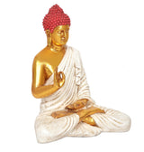 Close view Buddha statue, red jeweled crown, gold face, white robe, hands resting