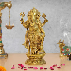 Brass standing Lord Ganesha idol with raised arms, round ornate base