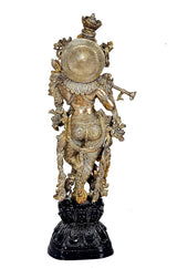 Brass Krishna murti with halo-like back disc, flute hand, elaborate carvings, dark base, 29 in.