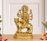 Brass Durga Maa idol seated on a tiger, multiple arms holding weapons and ritual objects