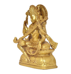 Golden brass Saraswati statue from side view, veena held diagonally, seated