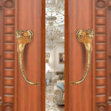 Brass Ganesha face door handle pair with curved levers, gold tone finish