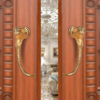 Brass Ganesha face door handle pair with curved levers, gold tone finish