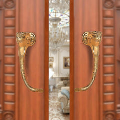 Brass Ganesha face door handle pair with curved levers, gold tone finish