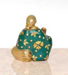 Brass Sai Baba statue from behind, teal back panel with gold flower and dot motifs