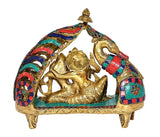 Brass Radha Krishna idol statue, angled close view of seated figures and arch