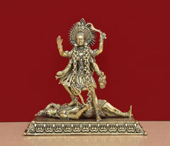 Mahakaali idol in brass, arms raised; ornate pedestal base with carved band