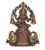 Saraswati brass idol on swan with veena, ornate arch, and gold-tone bell stands