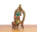 Side view Lakshmi brass idol, multicolor gemstone trim and detailed pedestal base