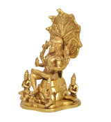 Brass Dakshinamurti Shiva statue, side view, seated figure with trident and ornate halo