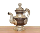 Traditional brass teapot showpiece, side spout opening, embossed emblem panel, chain handle