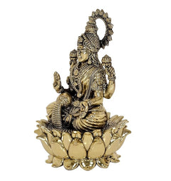 Side profile Lakshmi brass idol with lotus base, raised hand gesture and crown
