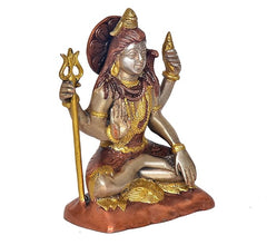 Shiva statue seated with trident beside left hand, right hand raised, brass and gold