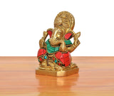 Brass Ganpati Bappa murti, side view, multicolor jewels on red and teal clothing