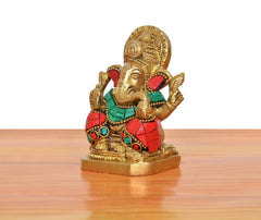 Brass Ganpati Bappa murti, side view, multicolor jewels on red and teal clothing