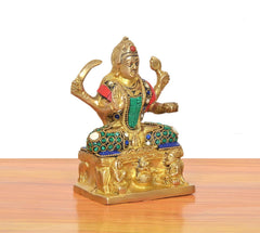 Santoshi Mata idol close side view, red sleeve and teal pendant with blue gems