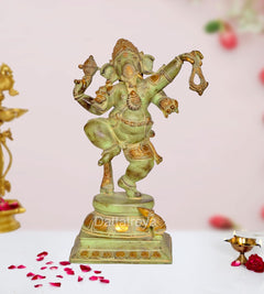 Brass dancing Ganesha idol statue with four arms, raised leg, ornate gold accents