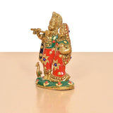 Brass Radha-Krishna idol from side, flute hand raised, red-and-green painted details