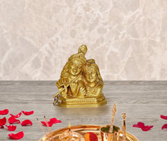 Radha Krishna idol statue, ornate gold-tone figures with raised flute and joined heads