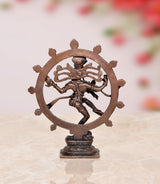 Back view of copper Nataraja Shiva idol inside circular halo, standing on pedestal
