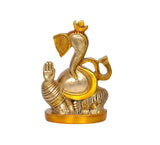 Brass Ganesha idol facing left, round belly, ornate trunk and crown