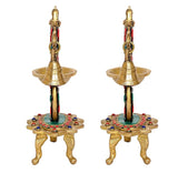 Brass diya stand pair, side view of two bells with jeweled colorful base