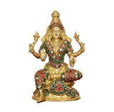 Brass Lakshmi goddess idol, front view seated on gold base with red and green gemstone accents