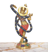Back view of brass Krishna sculpture with coiled serpent hood, multicolored red and blue motifs.