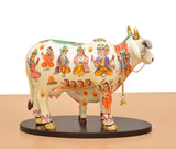 Resin Kamdhenu cow statue with calf, white base, colorful village figure motifs on side