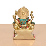 Brass Ganesha statue rear view, circular halo disk, turquoise beaded necklace, red accents