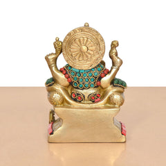 Brass Ganesha statue rear view, circular halo disk, turquoise beaded necklace, red accents