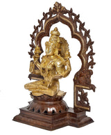 Brass Lakshmi idol side view with ornate halo frame and detailed seated lotus base