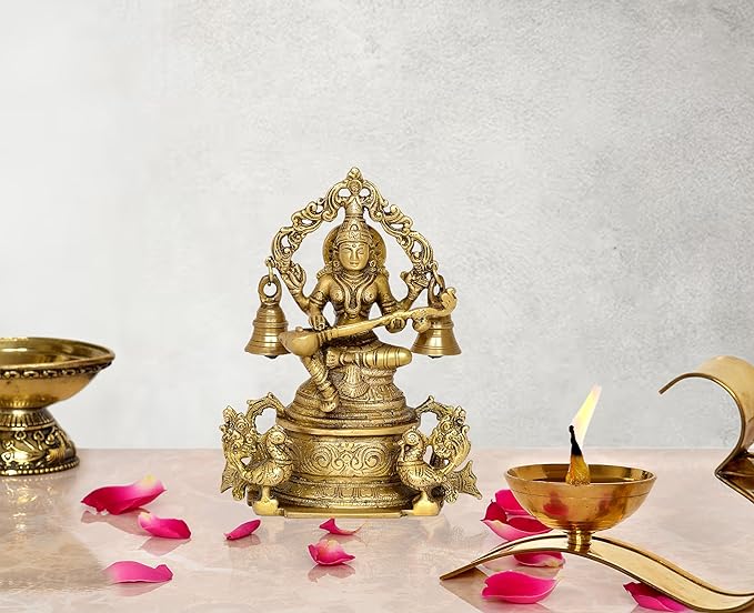 Brass Saraswati idol on ornate throne with four bells, 8 inch height