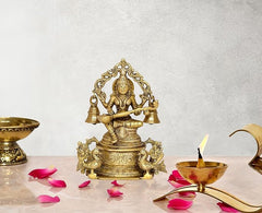 Brass Saraswati idol on ornate throne with four bells, 8 inch height