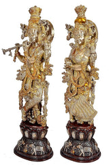 Brass Radha Krishna sculpture, back view showing ornate ornaments and dark pedestal