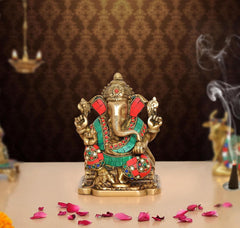 Brass Ganesh murti showpiece with red, green and blue jeweled clothing, front view