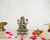 Brass Ganesha idol, seated on lotus base with four arms and ornate crown