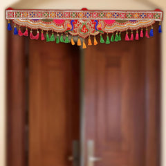 Peacock toran door hanging with red fabric, colorful tassels and central peacock motif