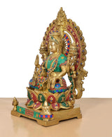 Lakshmi idol side view in gold-tone brass; teal robe with colorful painted accents